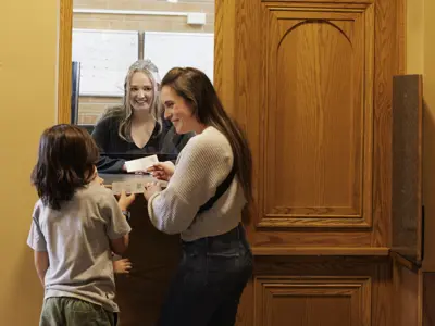 Young family picking up tickets at the Orillia Opera House