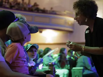 An usher at the Orillia Opera House helping audience members